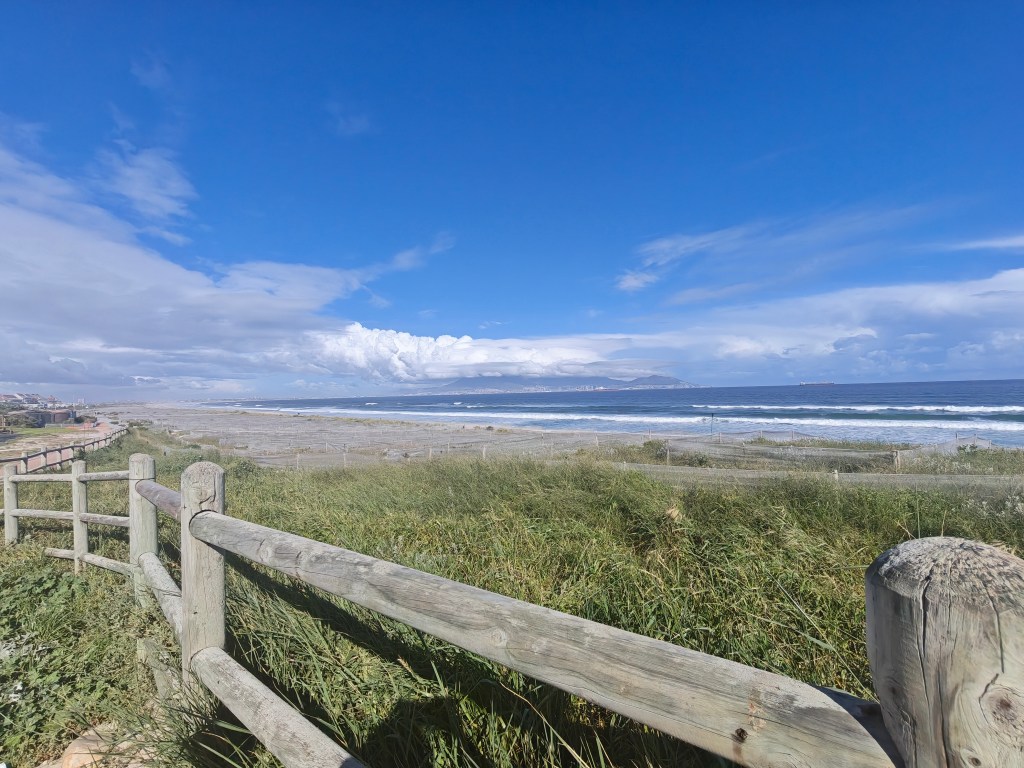 wide angle shot of table mountain with wooden fence in foreground